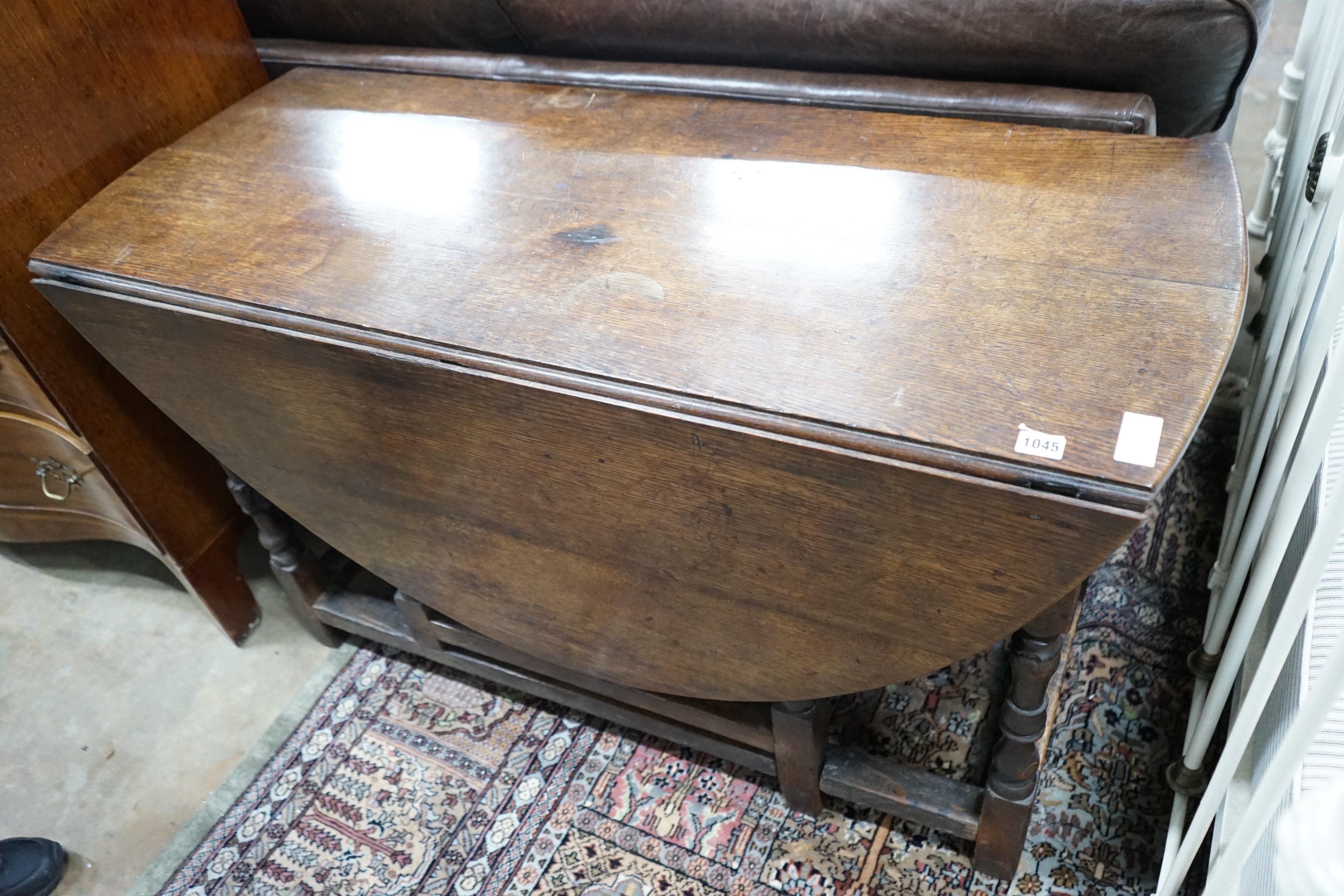 An 18th century oak gateleg dining table, length 141cm extended, width 120cm, height 74cm